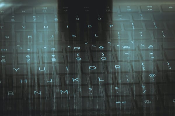 A computer keyboard with a sky background